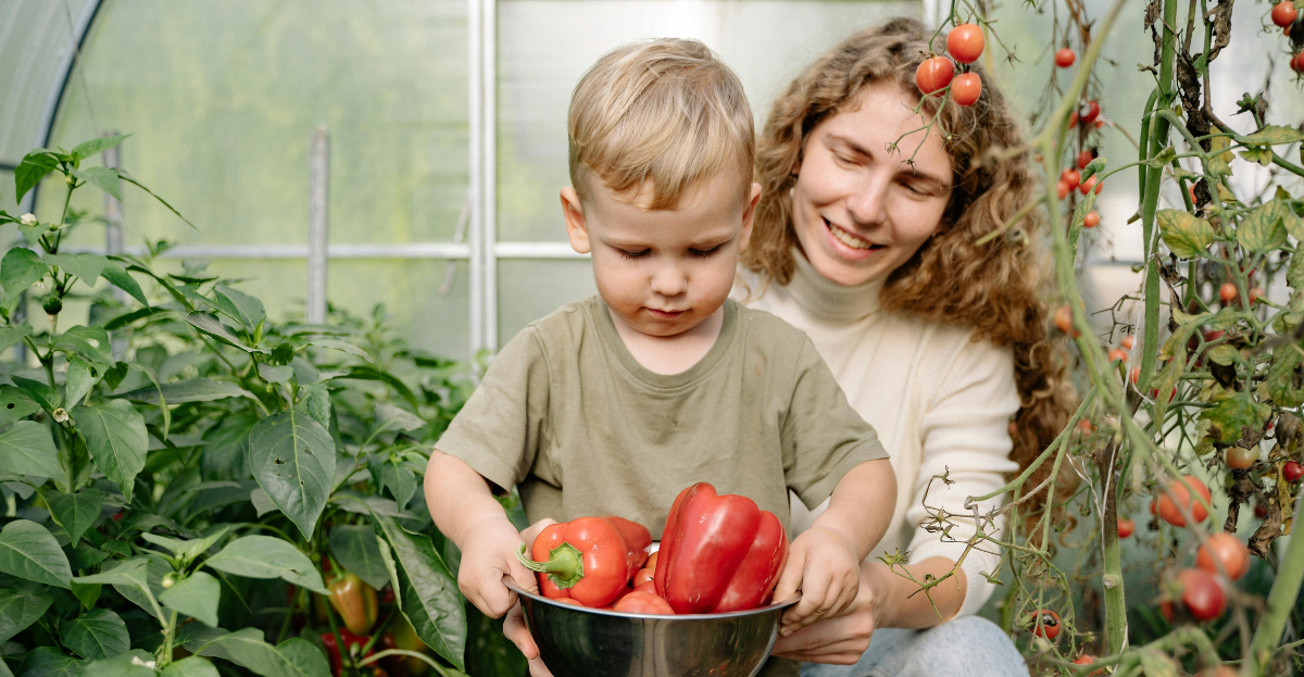Child with bowl of peppers